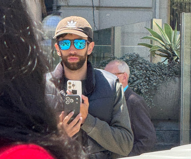 iPhone 17 Pro prototype with redesigned camera island and lower Apple logo spotted in public in protective case.